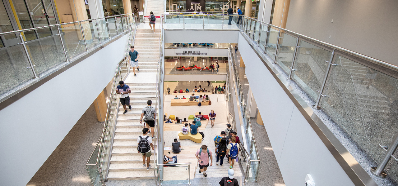 Students studying and gathering on the learning stairs at the Zachry Engineering Education Complex